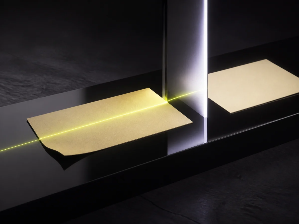 A flawed paper form passing through a critic beam and emerging corrected